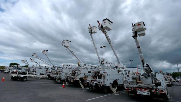 Electric utility trucks are lined up along Lake Pontchartrain in preparation for tropical storm Marco on August 24 in Kenner, Louisiana. The Gulf Coast is expecting to still see some impact from Marco. Shrimp trawlers and fishing boats have been tied up in a Louisiana harbour ahead of the storms. Both in-person classes and virtual school sessions are cancelled in some districts. (Sean Gardner/Getty Images/AFP)