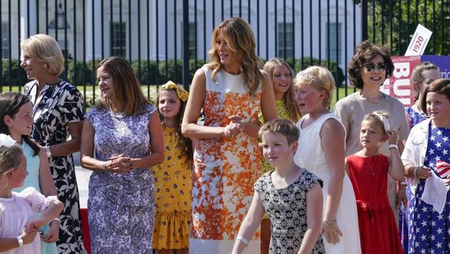 First lady Melania Trump visits an exhibit of artwork by young artists in celebration of the 100th anniversary of the 19th amendment which afforded the vote to women, at the White House in Washington, Monday, Aug. 24, 2020. She is joined by, from left, Education Secretary Betsy Devos, Second Lady Karen Pence, and Transportation Secretary Elaine Chao.(AP Photo/J. Scott Applewhite)