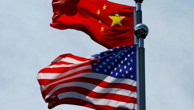 Chinese and US flags flutter near The Bund, before US trade delegation meet their Chinese counterparts for talks in Shanghai, China.(REUTERS)