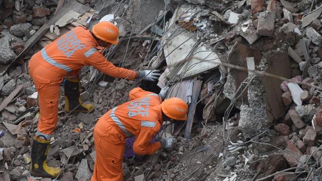 NDRF personnel search for survivors in the rubble of the collapsed building in Mahad on August 25. The building had 95 residents. While some managed to come out, around 25 people were feared trapped when the incident took place on August 24. (Punit Paranjpe / AFP) NDRF personnel search for survivors in the rubble of the collapsed building in Mahad on August 25. The building had 95 residents. While some managed to come out, around 25 people were feared trapped when the incident took place on August 24. (Punit Paranjpe / AFP)