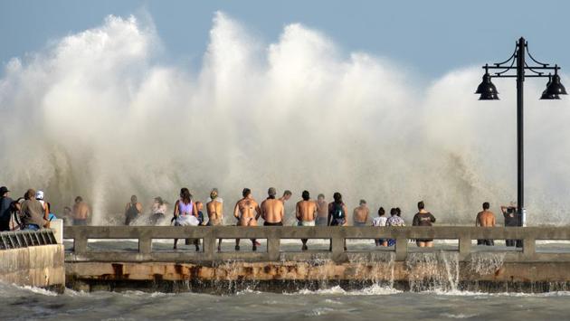 Curious residents in Key West, Florida, flock to the Edward B. Knight Pier on August 24 to witness the wind and wave action of tropical storm Laura as it passes well to the west of the Florida Keys. As tropical storm Marco made landfall, the Gulf Coast turned its attention to Laura, another system following just behind that could grow into a supercharged Category 3 hurricane with winds topping 177 kph. (Rob O'Neal/The Key West Citizen via AP)