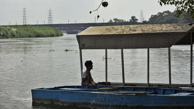 A boatman waits for customers by the banks of Yamuna as water levels rise at Nigambodh Ghat in New Delhi on August 25. According to government officials, preparations are already underway in case a higher volume of water is released and evacuation operations need to be launched. (Biplov Bhuyan / HT Photo)