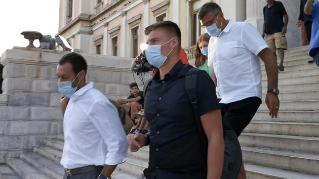 Manchester United player Harry Maguire's father, Alan, background leaves a court building with two other men after his son was found guilty of assault and attempting to bribe a police officer, on the Aegean island of Syros, Greece, Tuesday, Aug. 25, 2020. Maguire has been found guilty of assault at a trial and handed a 21-month suspended sentence following his arrest after a brawl last week on the island of Mykonos, court officials in Greece said. (Giorgos Solaris/InTime News via AP)(AP)