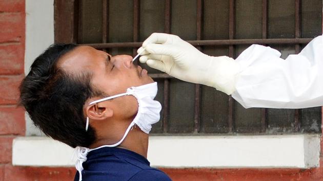 A medic collects a sample at a testing booth at CHC Model Town in Patiala on Tuesday.(File Photo)