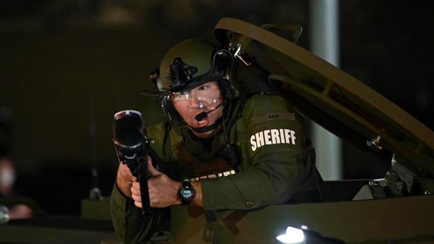 A law enforcement officer holds a weapon as he stands in the hatch of an armoured vehicle during a protest outside the Kenosha County Courthouse in Kenosha, Wisconsin on August 25. The police told AP that they were responding to a call about a domestic dispute when they encountered Blake on August 23 and intimated no details on whether Blake was armed or why police opened fire. (Stephen Maturen / REUTERS) A law enforcement officer holds a weapon as he stands in the hatch of an armoured vehicle during a protest outside the Kenosha County Courthouse in Kenosha, Wisconsin on August 25. The police told AP that they were responding to a call about a domestic dispute when they encountered Blake on August 23 and intimated no details on whether Blake was armed or why police opened fire. (Stephen Maturen / REUTERS)