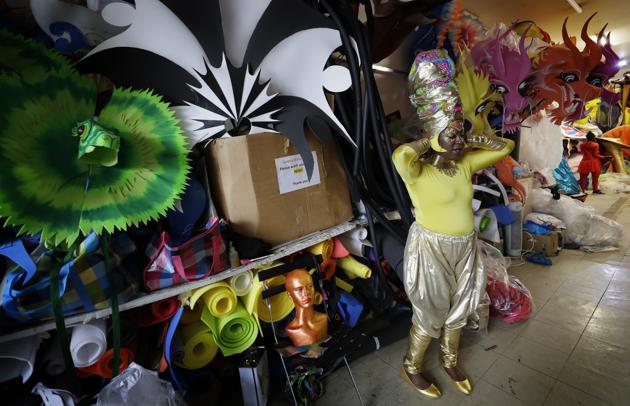 Carolyn Roberts-Griffith adjusts her costume for a prepping event ahead of this year's Notting Hill Carnival which will be held virtually, in London, Thursday, Aug. 20, 2020. London's Notting Hill Carnival traces its roots to the emancipation of Black slaves and race riots in the city during the late 1950s. Organizers say the event is more important than ever amid the worldwide campaign for justice following the death of George Floyd in police custody. But their message of resistance and reconciliation will be delivered online worldwide this weekend after the COVID-19 pandemic forced the party to reinvent itself as a virtual event. (AP Photo/Kirsty Wigglesworth) (AP) Carolyn Roberts-Griffith adjusts her costume for a prepping event ahead of this year's Notting Hill Carnival which will be held virtually, in London, Thursday, Aug. 20, 2020. London's Notting Hill Carnival traces its roots to the emancipation of Black slaves and race riots in the city during the late 1950s. Organizers say the event is more important than ever amid the worldwide campaign for justice following the death of George Floyd in police custody. But their message of resistance and reconciliation will be delivered online worldwide this weekend after the COVID-19 pandemic forced the party to reinvent itself as a virtual event. (AP Photo/Kirsty Wigglesworth) (AP)