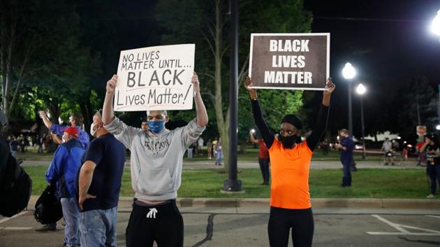 Protestors hold signs of “Black Lives Matter” during a demonstration in Kenosha, Wisconsin on August 25. Jacob Blake’s shooting is the fourth incident this summer that has sparked discourses of racial unrest that started with deaths of George Floyd in Minneapolis, Rayshard Brooks in Atlanta and Breonna Taylor in Louisville, Kentucky, reported AP. (Kamil Krzaczynski / AFP) Protestors hold signs of “Black Lives Matter” during a demonstration in Kenosha, Wisconsin on August 25. Jacob Blake’s shooting is the fourth incident this summer that has sparked discourses of racial unrest that started with deaths of George Floyd in Minneapolis, Rayshard Brooks in Atlanta and Breonna Taylor in Louisville, Kentucky, reported AP. (Kamil Krzaczynski / AFP)
