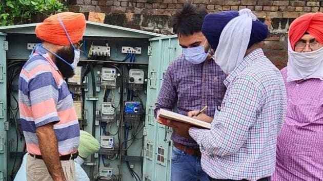 PSPCL officials checking electricity meters in Khanna on Thursday.(HT Photo)