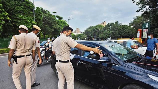 Delhi Police personnel penalizes commuters for violation of Covid-19 protocols at Connaught Place area in New Delhi, India, on Monday, August 24, 2020. (Photo by Raj K Raj/ Hindustan Times)