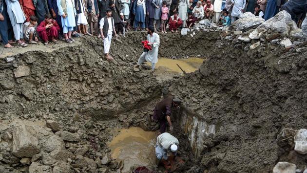 Villagers and rescuers search for bodies among debris at Sayrah-e-Hopiyan in Charikar on August 26. The death toll rose to 150 on August 27 as survivors and rescue workers screened through the debris of more than 1,500 homes that were destroyed in the flash floods, Reuters reported. (Wakil Kohsar / AFP)