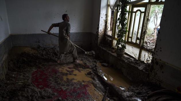A villager uses a shovel to clear the mud inside his home after the flash floods at Sayrah-e-Hopiyan in Charikar on August 26. Survivors said many children were among the dead. The death toll is expected to rise as families prepared for mass burials with extensive rubble yet to be cleared. (Wakil Kohsar / AFP)
