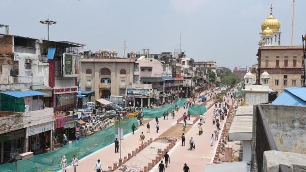 People seen walking on a newly constructed stretch at Chandni Chowk. The DCP said police received a call about the hanging of the brothers on the third floor of their shop.(Arvind Yadav/HT PHOTO)