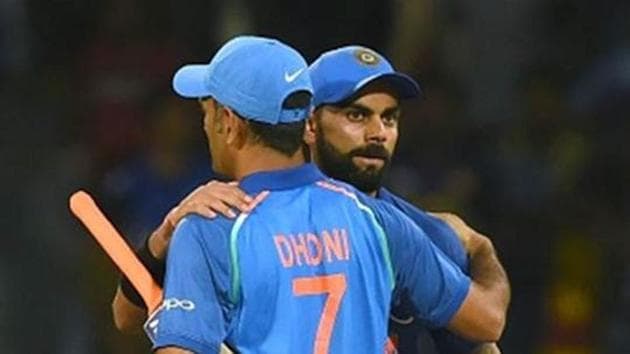 Indian cricket captain Virat Kohli (R) celebrates with teammate Mahendra Singh Dhoni (L)(AFP/Getty Images)