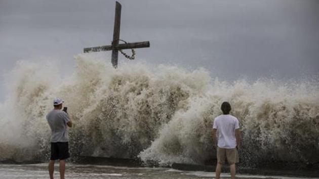 Waves crash ashore as outer bands from Hurricane Laura begin to hit the coast (AP)
