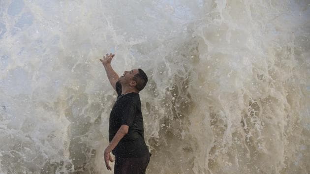 A resident of Galveston, Texas feels a wave as it hits the seawall while watching the surf stirred up by Hurricane Laura, on Wednesday. (AP Photo) A resident of Galveston, Texas feels a wave as it hits the seawall while watching the surf stirred up by Hurricane Laura, on Wednesday. (AP Photo)
