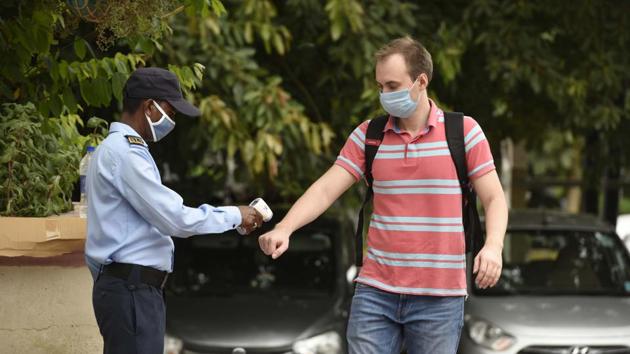A security guard checks the body temperature of a visitor at the entrance of Galleria Market in Gurugram on August 26. According to the worldometers coronavirus tracker India’s Covid-19 case tally currently rests at 3,314,953 cases. (Parveen Kumar / HT Photo) 