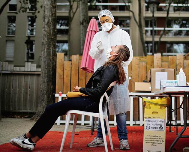 Healthcare workers collect swab for testing in Paris. (Reuters) Healthcare workers collect swab for testing in Paris. (Reuters)