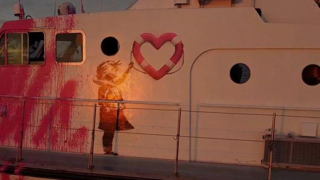 In this still image taken from video a Banksy graffiti in seen on the Louise Michel, a migrants search and rescue ship operating in the Mediterranean and financed by British street artist Banksy, is seen at sea, August 17, 2020.  (via REUTERS) 