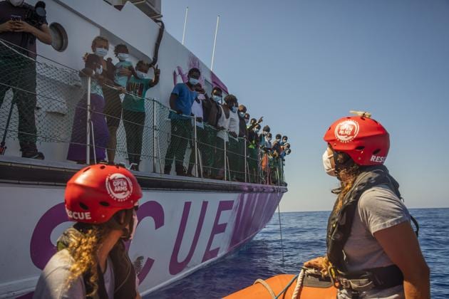 Members of the Astral crew, a rescue ship from the Spanish NGO Open Arms, approach the Louise Michel rescue vessel, a French patrol boat currently manned by activists and funded by the renowned artist Banksy in the Central Mediterranean sea, at 50 miles south from Lampedusa, Friday, Aug. 28, 2020.  (AP) 