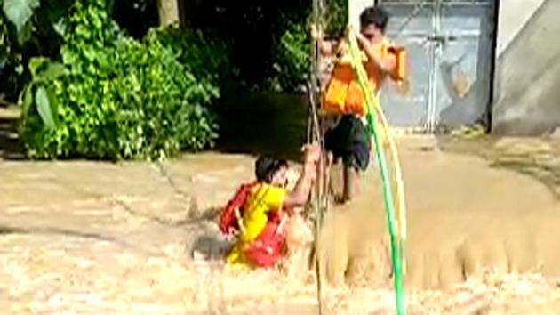 Fire services personnel of Bari Fire Station rescue 6 people, including a newborn baby, from a flooded village in Jajpur on Aug 28, 2020.(ANI) Fire services personnel of Bari Fire Station rescue 6 people, including a newborn baby, from a flooded village in Jajpur on Aug 28, 2020.(ANI)