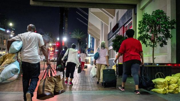 Evacuees fleeing Lake Charles and the path of Hurricane Laura check into the New Orleans Marriott where the state of Louisiana requested several hundred rooms be reserved in New Orleans on August 27. More than 580,000 coastal residents evacuated in what was the largest evacuation order since the Covid-19 pandemic began, filling hotels and sleeping in cars, the AP reported. (Kathleen Flynn / REUTERS) Evacuees fleeing Lake Charles and the path of Hurricane Laura check into the New Orleans Marriott where the state of Louisiana requested several hundred rooms be reserved in New Orleans on August 27. More than 580,000 coastal residents evacuated in what was the largest evacuation order since the Covid-19 pandemic began, filling hotels and sleeping in cars, the AP reported. (Kathleen Flynn / REUTERS)