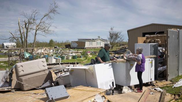 Michael and Darlene Taylor sort their belongings damaged by Hurricane Laura on August 27 in Grand Lake, Louisiana. Hurricane Laura came ashore on August 27 bringing rain and high winds to the south east region of the state, reaching wind speeds of 241 kph and a 9-12 feet storm surge. (Eric Thayer / Getty Images / AFP) Michael and Darlene Taylor sort their belongings damaged by Hurricane Laura on August 27 in Grand Lake, Louisiana. Hurricane Laura came ashore on August 27 bringing rain and high winds to the south east region of the state, reaching wind speeds of 241 kph and a 9-12 feet storm surge. (Eric Thayer / Getty Images / AFP)