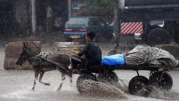 A man rides on a donkey led cart during heavy rain in Karachi on August 27. According to a Pakistan Meteorological Department (PMD) report, nearly 484 mm (19 inches) of rain has fallen this month and of that 130 mm on August 27 alone. (Asif Hassan / AFP) A man rides on a donkey led cart during heavy rain in Karachi on August 27. According to a Pakistan Meteorological Department (PMD) report, nearly 484 mm (19 inches) of rain has fallen this month and of that 130 mm on August 27 alone. (Asif Hassan / AFP)