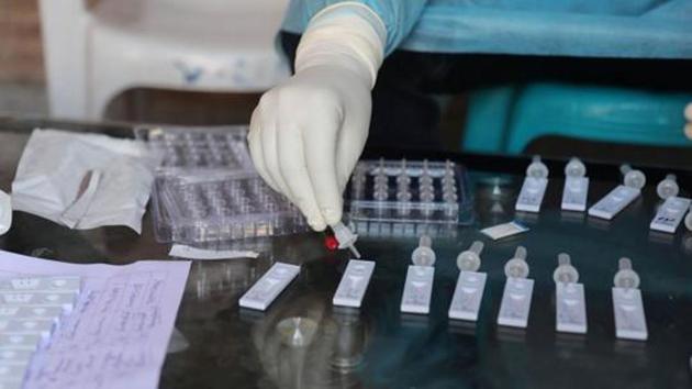 A health worker conducts coronavirus test from the collected swab samples in Srinagar. (Waseem Andrabi/HT file photo)