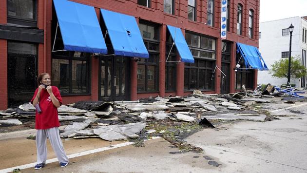 A woman observes the damage to businesses in downtown Lake Charles, in the aftermath of Hurricane Laura on August 27. Residents of Lake Charles heard Laura’s winds and the sound of breaking glass as the storm passed through the casino city of 78,000. (Gerald Herbert / AP) A woman observes the damage to businesses in downtown Lake Charles, in the aftermath of Hurricane Laura on August 27. Residents of Lake Charles heard Laura’s winds and the sound of breaking glass as the storm passed through the casino city of 78,000. (Gerald Herbert / AP)