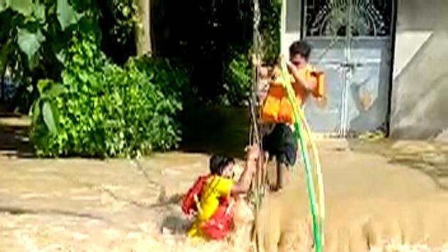 Fire services personnel of Bari Fire Station rescue people from a flooded village in Jajpur on Friday.(ANI photo)