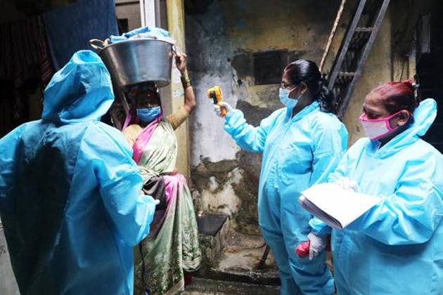 Healthcare workers wearing personal protective equipment (PPE) conduct door to door thermal screening of residents during a campaign to detect the coronavirus disease (Covid-19) in Mumbai’s Dharavi. There were 76,472 new infections in the last 24 hours, according to the health ministry’s dashboard.(ANI Photo)