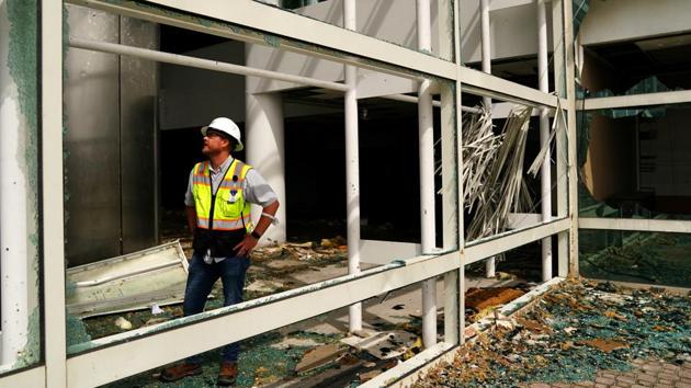 A man checks a damaged building after Hurricane Laura passed through Lake Charles, Louisiana. (Reuters)