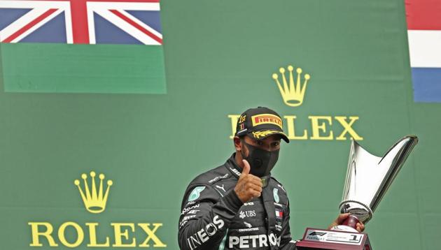 Mercedes driver Lewis Hamilton of Britain gives the thumbs up as he holds his trophy on the podium after placing first in the Formula One Grand Prix at the Spa-Francorchamps racetrack in Spa, Belgium, Sunday, Aug. 30, 2020. (AP Photo/Francisco Seco, Pool)(AP)