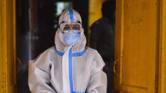 A health worker in PPE coveralls stands in a doorway before the start of collection of swab samples for coronavirus testing, at a testing centre, in Janakpuri, in New Delhi.(Sanchit Khanna/HT PHOTO) A health worker in PPE coveralls stands in a doorway before the start of collection of swab samples for coronavirus testing, at a testing centre, in Janakpuri, in New Delhi.(Sanchit Khanna/HT PHOTO)