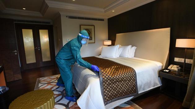 An employee in PPE coveralls makes a bed in a room at the Taj Palace hotel in New Delhi on August 28. Despite the surge in recent weeks, India continues to ease restrictions put originally into effect as part of the lockdown in March. Attempts to stabilise economic activity come as the economy faces its biggest contraction in four decades, Bloomberg reported. (Ajay Aggarwal /HT Photo)