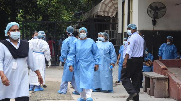 Medical staff wearing PPE suits seen outside Lok Nayak Jai Prakash (LNJP) Hospital in New Delhi.(Raj K Raj/HT PHOTO)