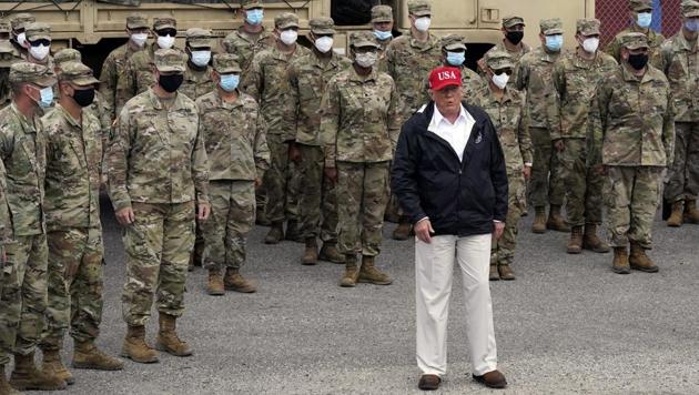 President Donald Trump stands with members of the Louisiana National Guard helping with recovery efforts from Hurricane Laura, Saturday.(AP photo)