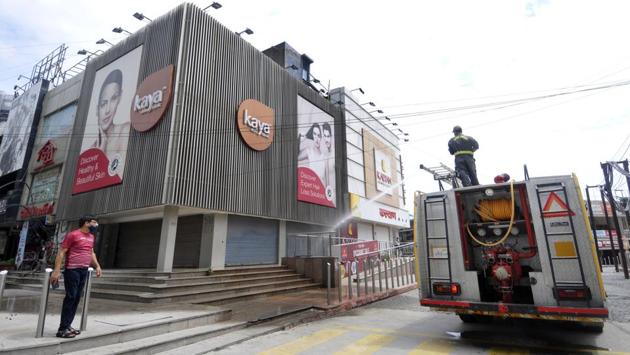 Fire services personnel chemically disinfect a market premises during a weekend lockdown imposed by the state government in Noida on August 29. From a former president to multiple ministers in Prime Minister Narendra Modi’s cabinet, the virus has spread further from India’s biggest cities to its vast hinterland. (Sunil Ghosh / HT Photo)