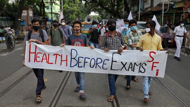 Students wearing protective face masks carry a banner as they participate in a protest march demanding postponement of admission tests to medical and engineering schools amidst the spread of the coronavirus in Kolkata on August 29. (Rupak De Chowdhuri / REUTERS)