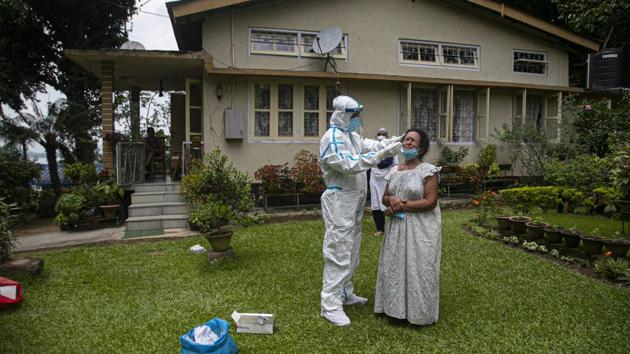 A health worker takes a nasal swab sample to test for Covid-19 during a door to door test drive in Guwahati on August 29. India’s Covid-19 cases rose to 3.6 million on August 30, a day after the world’s second most populous nation announced a global record of 78,761 single-day coronavirus infections. (Anupam Nath / AP)