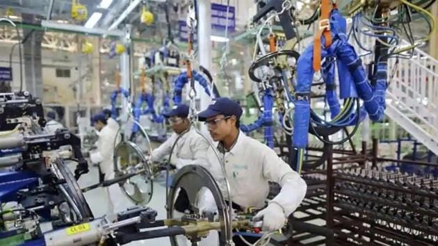 Employees work at the assembly line of the Honda Amaze car inside the company’s manufacturing plant in Tapukara, Rajasthan.(Reuters File Photo)