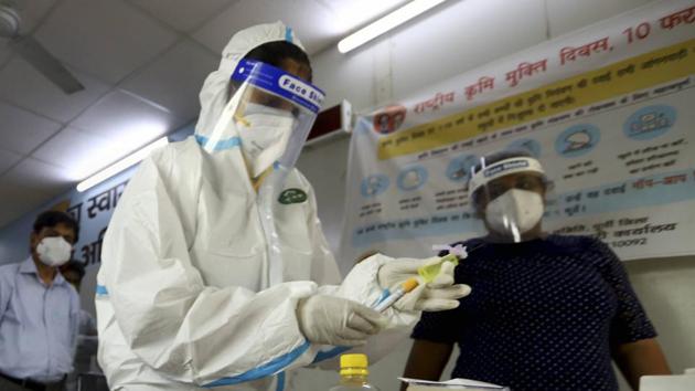 Medics collect blood sample of residents for serological survey at a clinic in east Delhi on June 30. (PTI)