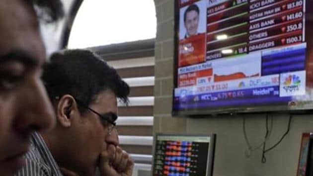 Stockbrokers watch the Bombay Stock Exchange (BSE) index on a trading terminal in Mumbai.(AP File Photo)