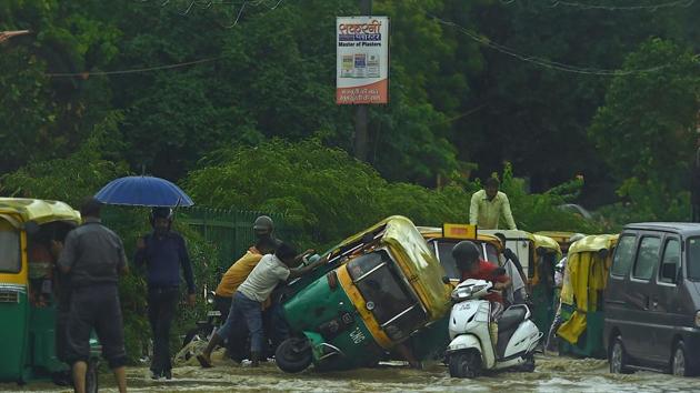People try to pull an overturned auto rickshaw along a waterlogged road following monsoon rainfalls in New Delhi . The death toll from the torrential monsoon rains across South Asia has risen to nearly 1,300 as Bangladesh experienced its second-worst floods since independence and Nepal reeled from several fatal landslides.(AFP) People try to pull an overturned auto rickshaw along a waterlogged road following monsoon rainfalls in New Delhi . The death toll from the torrential monsoon rains across South Asia has risen to nearly 1,300 as Bangladesh experienced its second-worst floods since independence and Nepal reeled from several fatal landslides.(AFP)