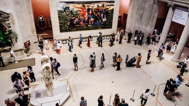 Visitors tour the museum in a line during its public reopening in New York on August 29. With the reopening, museums are ready to reclaim the public space after countless exhibitions in galleries and museum have been cancelled or postponed due to the pandemic. The Met alone has already cut 400 jobs and expects to lose $150 million in revenue due to the pandemic, Bloomberg reported. (Nina Westervelt / Bloomberg) Visitors tour the museum in a line during its public reopening in New York on August 29. With the reopening, museums are ready to reclaim the public space after countless exhibitions in galleries and museum have been cancelled or postponed due to the pandemic. The Met alone has already cut 400 jobs and expects to lose $150 million in revenue due to the pandemic, Bloomberg reported. (Nina Westervelt / Bloomberg)