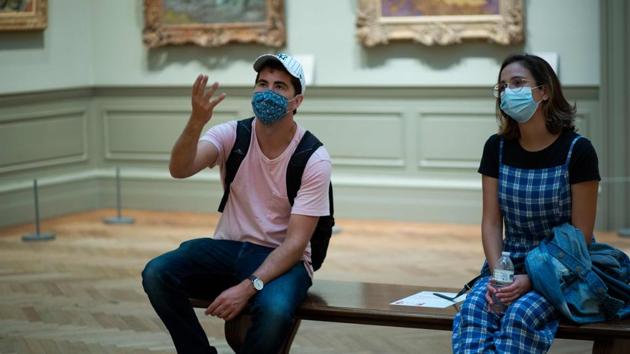 Visitors discuss an artwork during their visit to Metropolitan Museum of Art in New York on August 29. But on the other side, the silver lining with having fewer crowds is a more immersive tour for each visitor. “I think it will increase your enjoyment of the experience,” Laurel Britton, senior vice president for revenue and operations told AFP. “We are going to be a hyper local museum,” she said. (Kena Betancur / AFP) Visitors discuss an artwork during their visit to Metropolitan Museum of Art in New York on August 29. But on the other side, the silver lining with having fewer crowds is a more immersive tour for each visitor. “I think it will increase your enjoyment of the experience,” Laurel Britton, senior vice president for revenue and operations told AFP. “We are going to be a hyper local museum,” she said. (Kena Betancur / AFP)