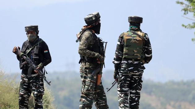 Security personnel stand guard near the encounter site in Baramulla.(AN)