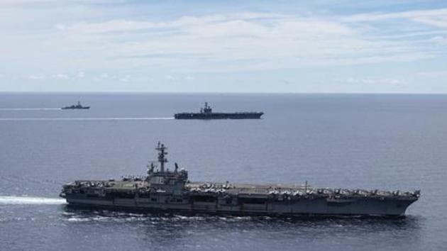 USS Ronald Reagan (CVN 76, front) and USS Nimitz (CVN 68, rear) Carrier Strike Groups sail together in formation, in the South China Sea.(AP)