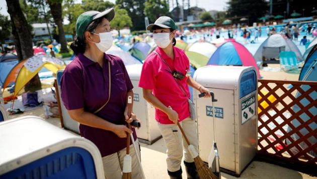 Employees of Toshimaen amusement park Junko Abe, 62, and her daughter Hikari, 30, conduct a cleaning work together, amid the coronavirus disease (COVID-19) outbreak, at the park which will close 94 years after it first opened with part of the site to be turned into a new Harry Potter theme park in 2023, in Tokyo, Japan. (REUTERS/Issei Kato)