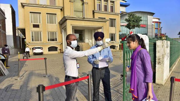 A candidate appearing for JEE Main undergoing thermal screening at the entry gate of the examination centre near Sherpur Chowk in Ludhiana on Tuesday(Gurpreet Singh/HT)